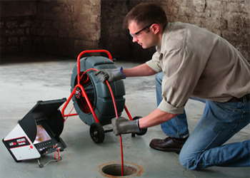 Boulder drain cleaning technician uses a SeeSnake to spot a clog