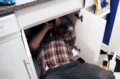 Boulder plumbing professional repairs a sink drain